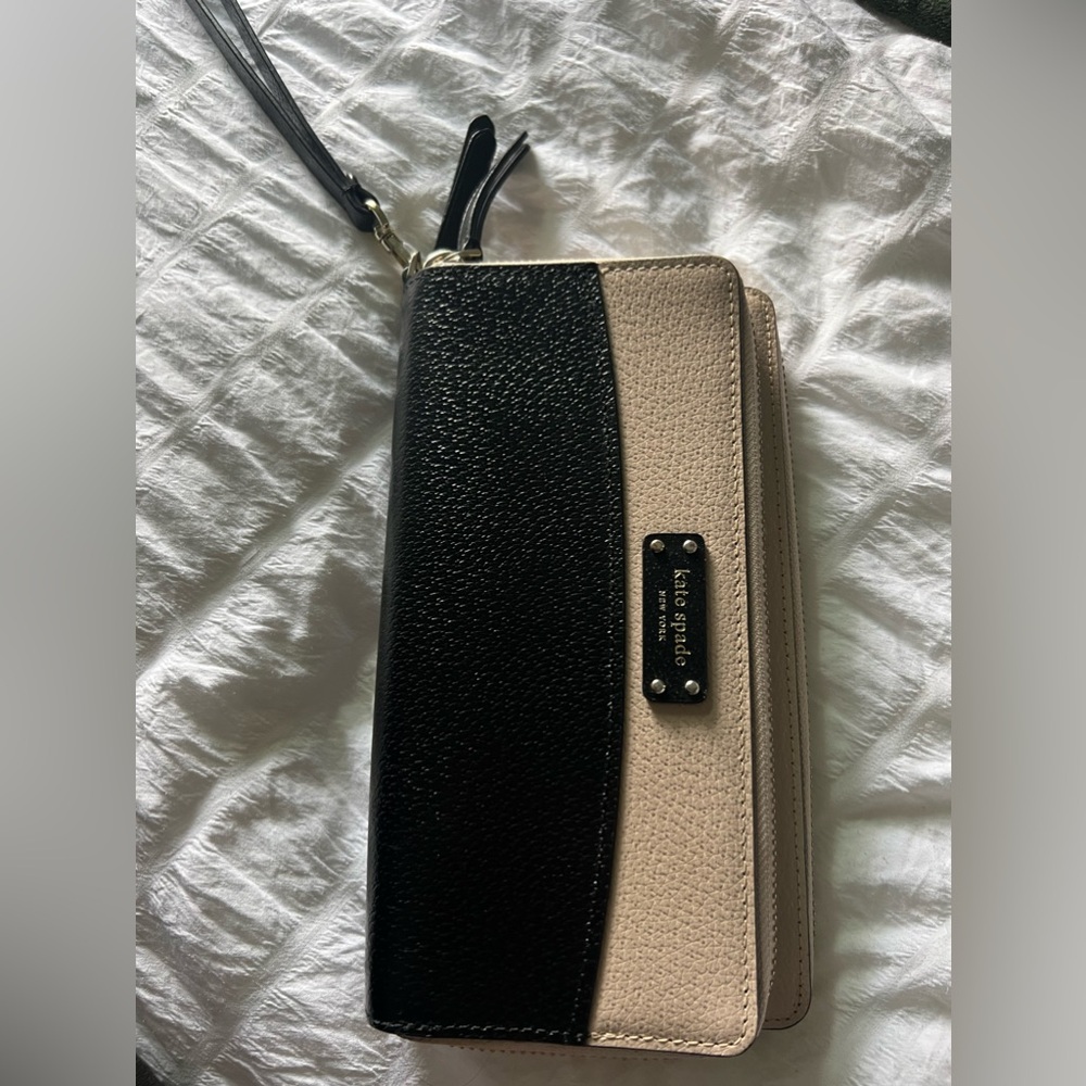 Kate spade New York black and cream wristlet wallet.